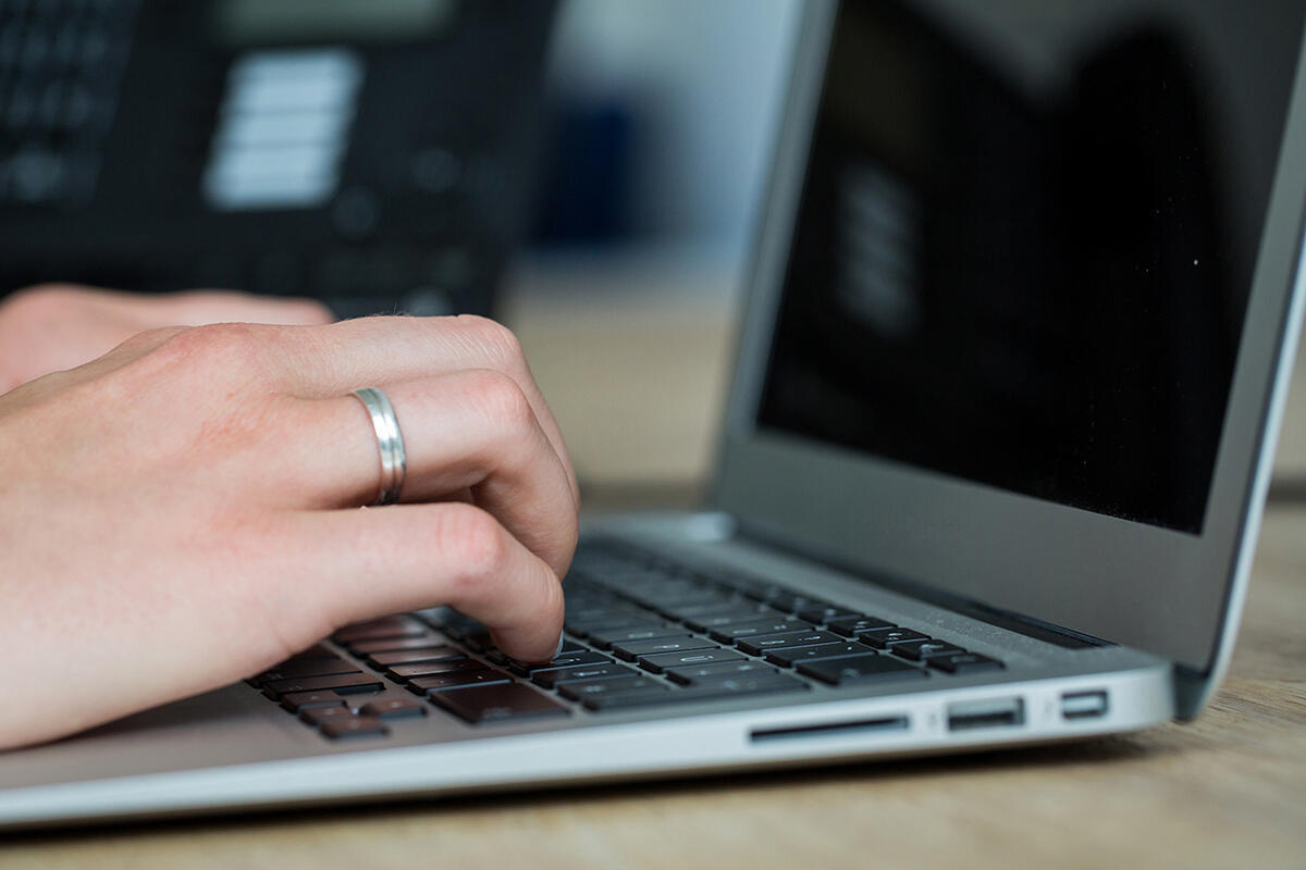 Hände tippen auf Computertastatur